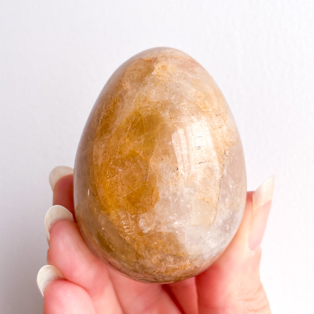 Golden healer quartz crystal polished egg with stand