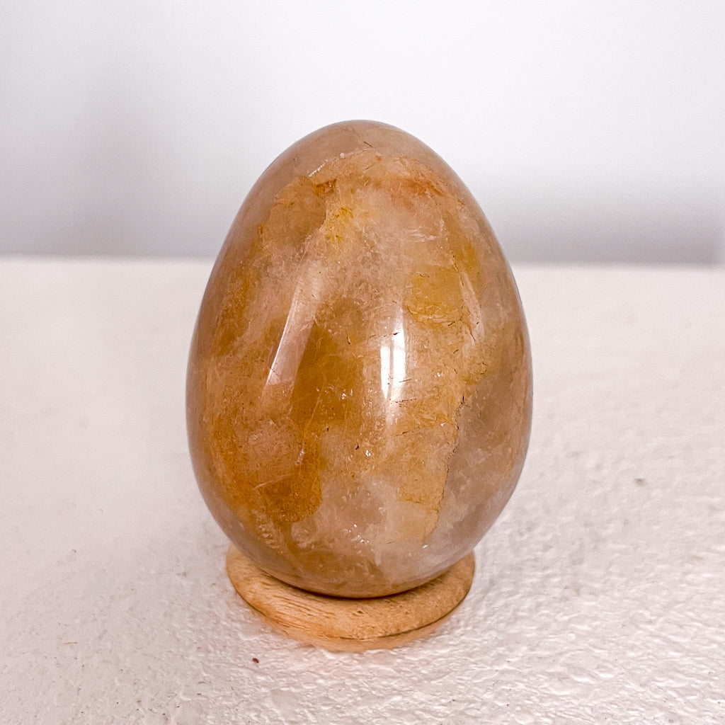 Golden healer quartz crystal polished egg with stand