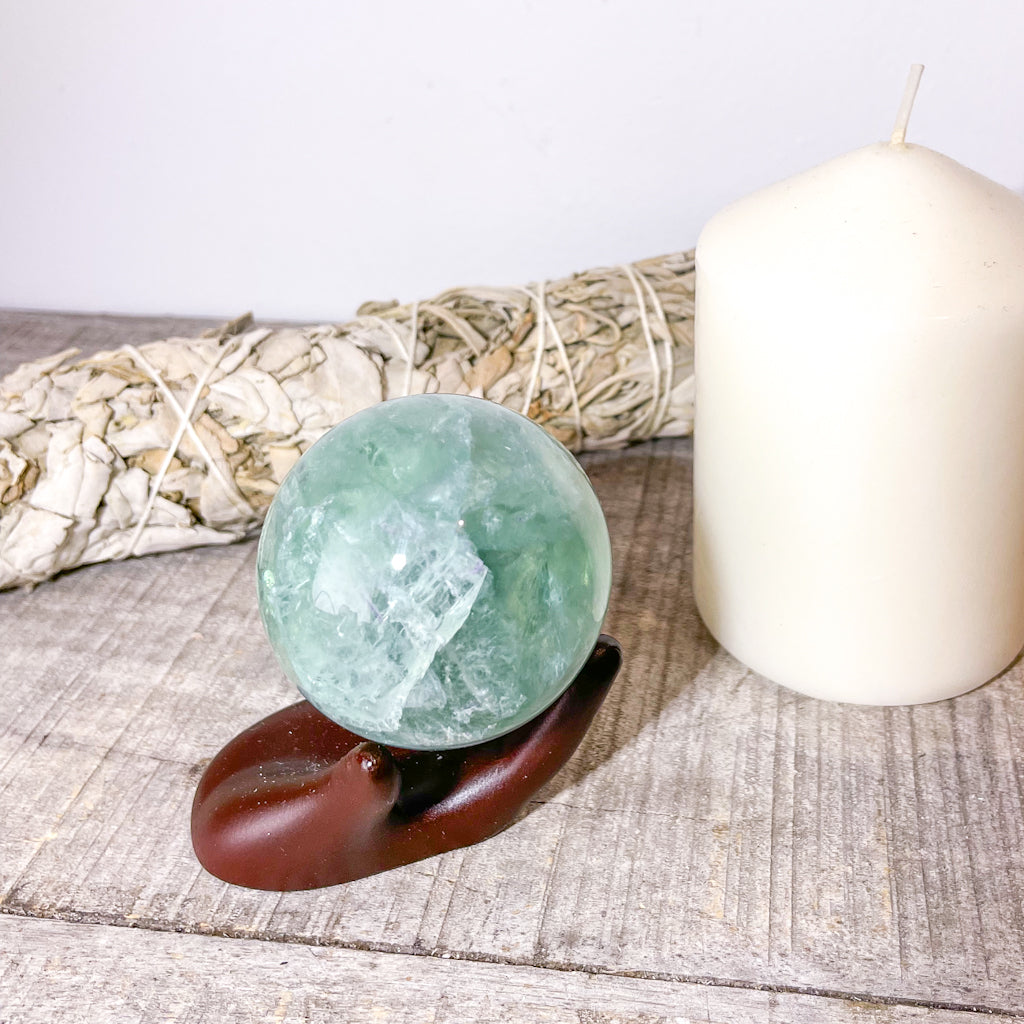 Fluorite green crystal polished sphere with rainbow inclusions