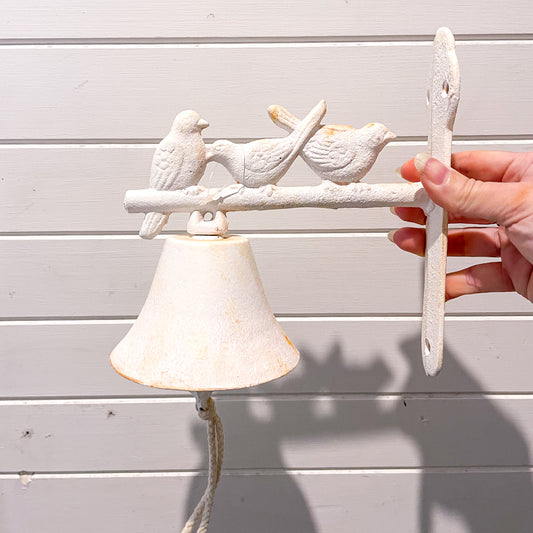 White washed antique style door bell with birds