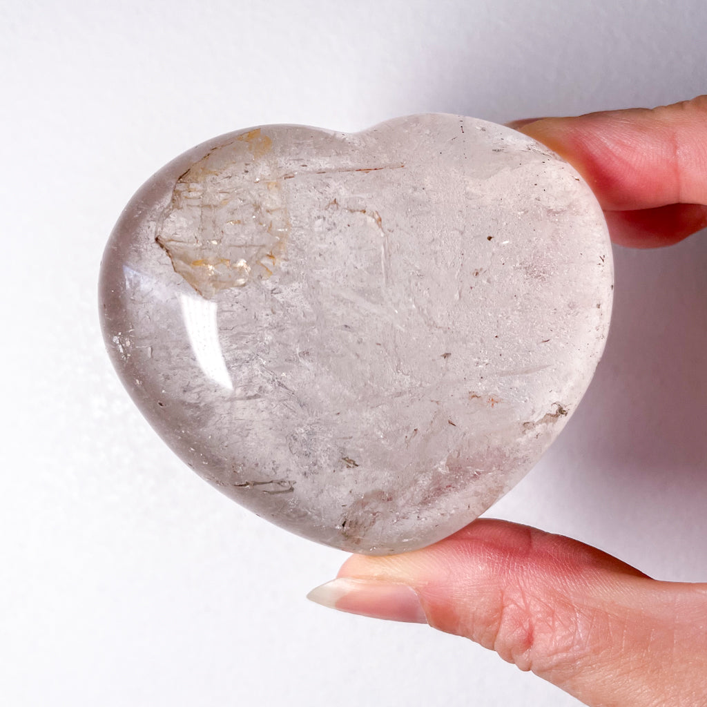 Clear quartz crystal heart with inclusions