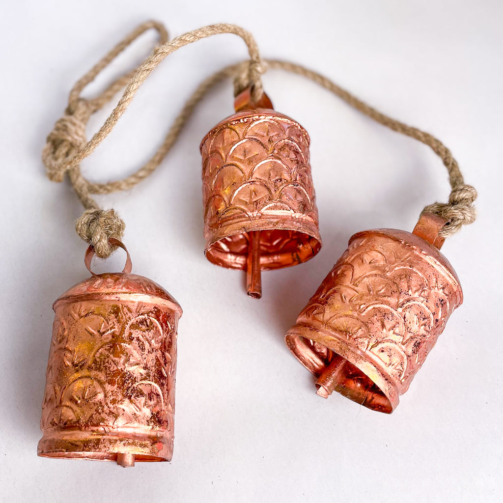 Ornate cow bells wind chime in rose gold copper