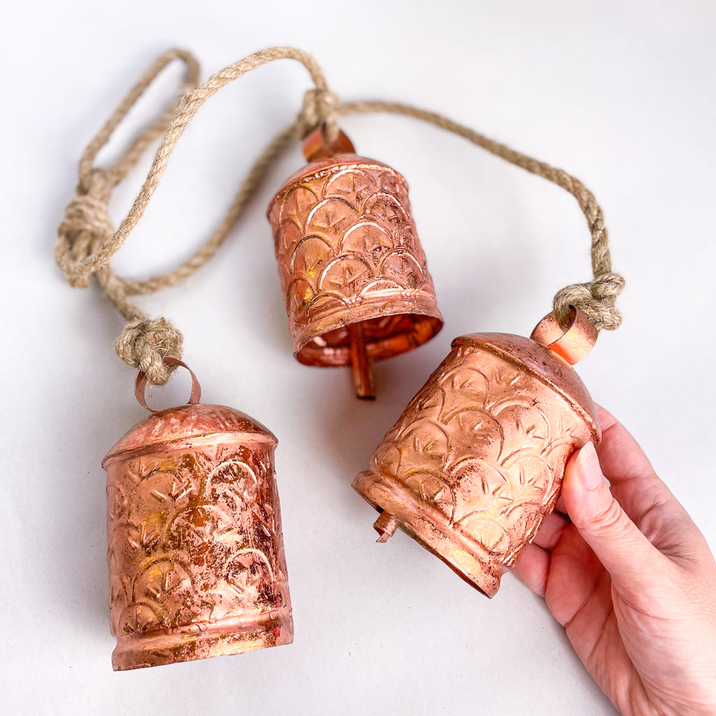 Ornate cow bells wind chime in rose gold copper