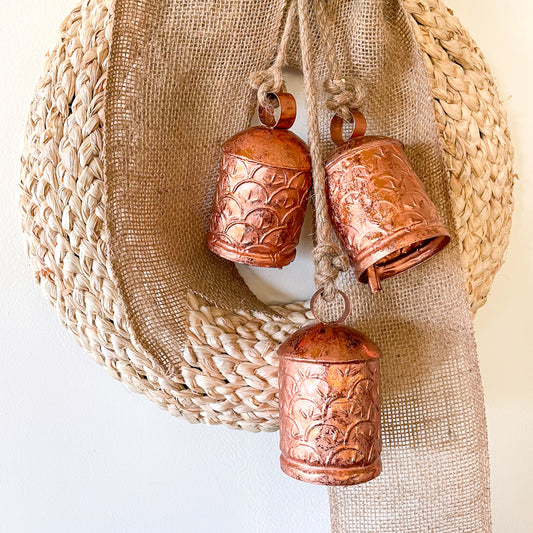 Ornate cow bells wind chime in rose gold brass
