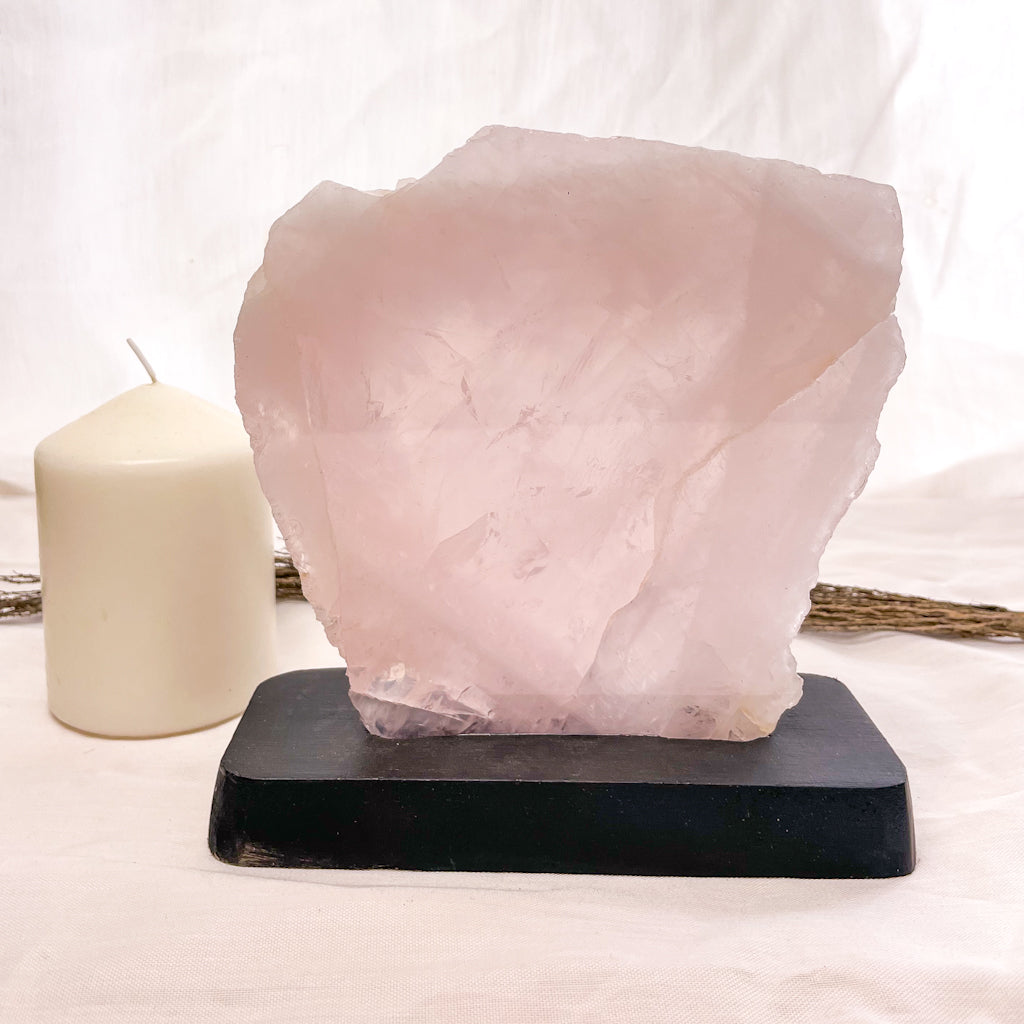 Rose quartz crystal polished slab on black stand