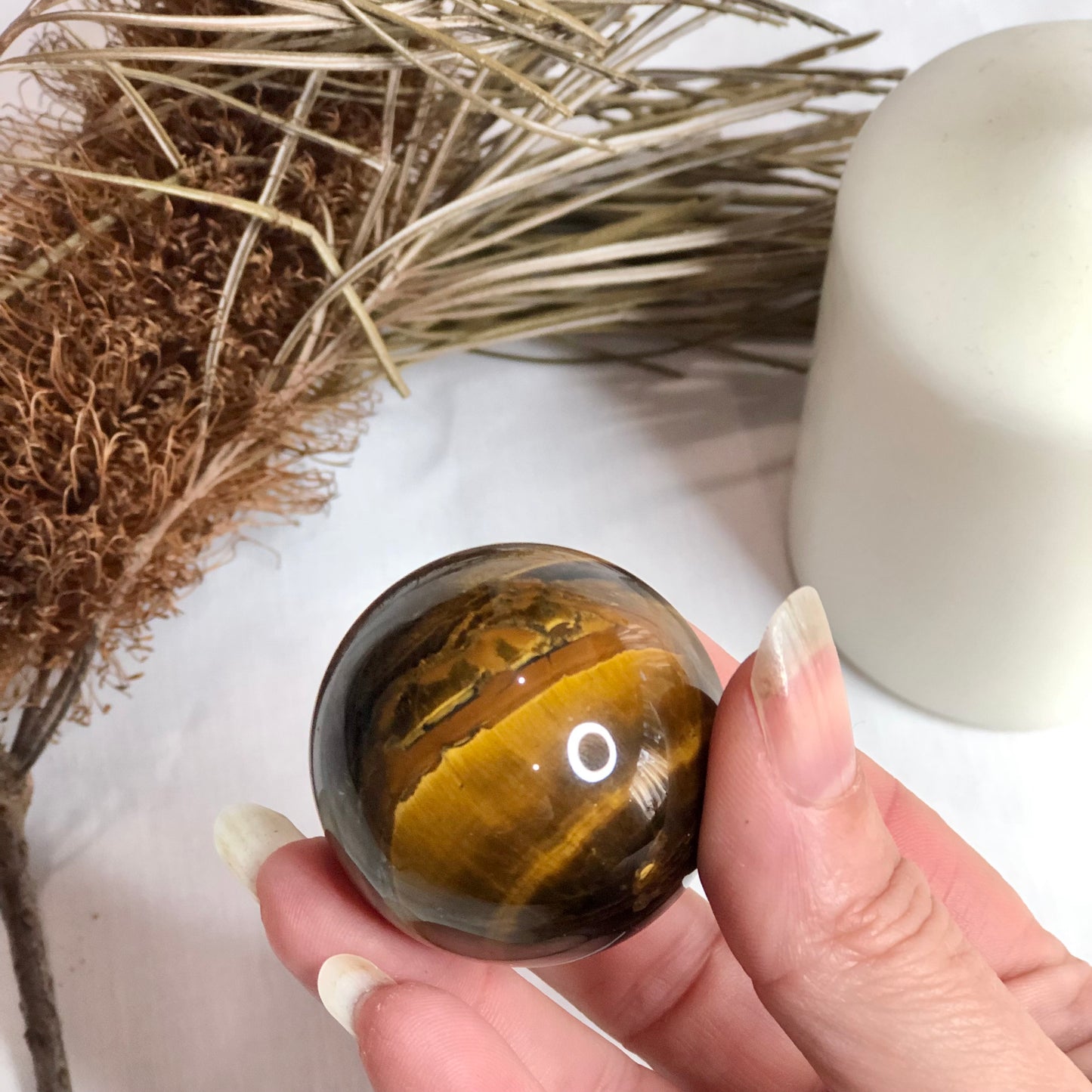 Tigers eye crystal palm stone sphere