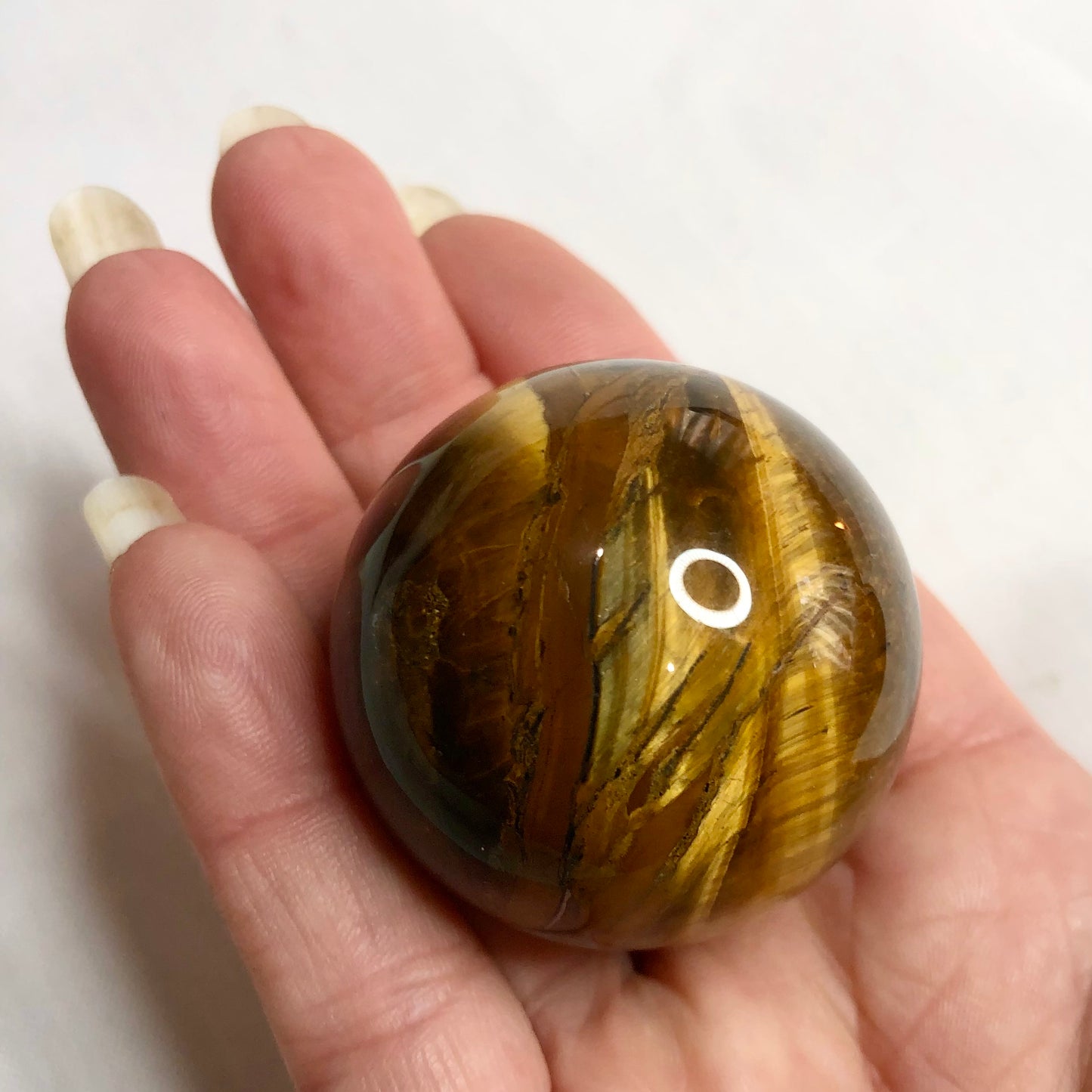 Tigers eye crystal palm stone sphere