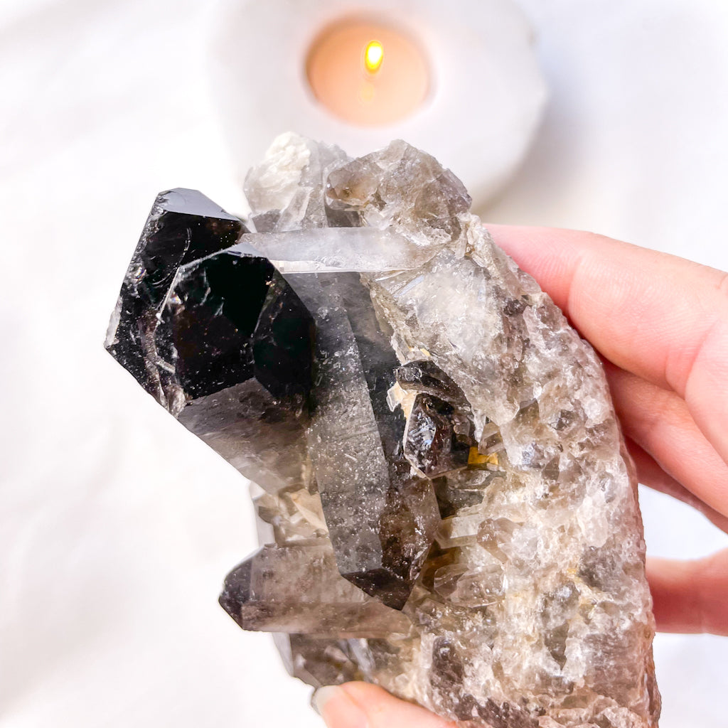 Smoky quartz crystal cluster on stand