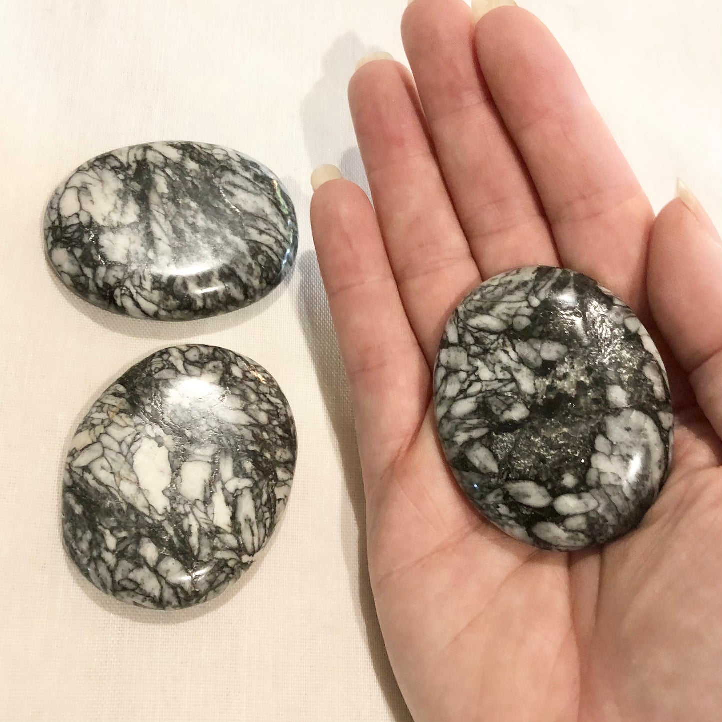 Pinolite crystal polished palm stone