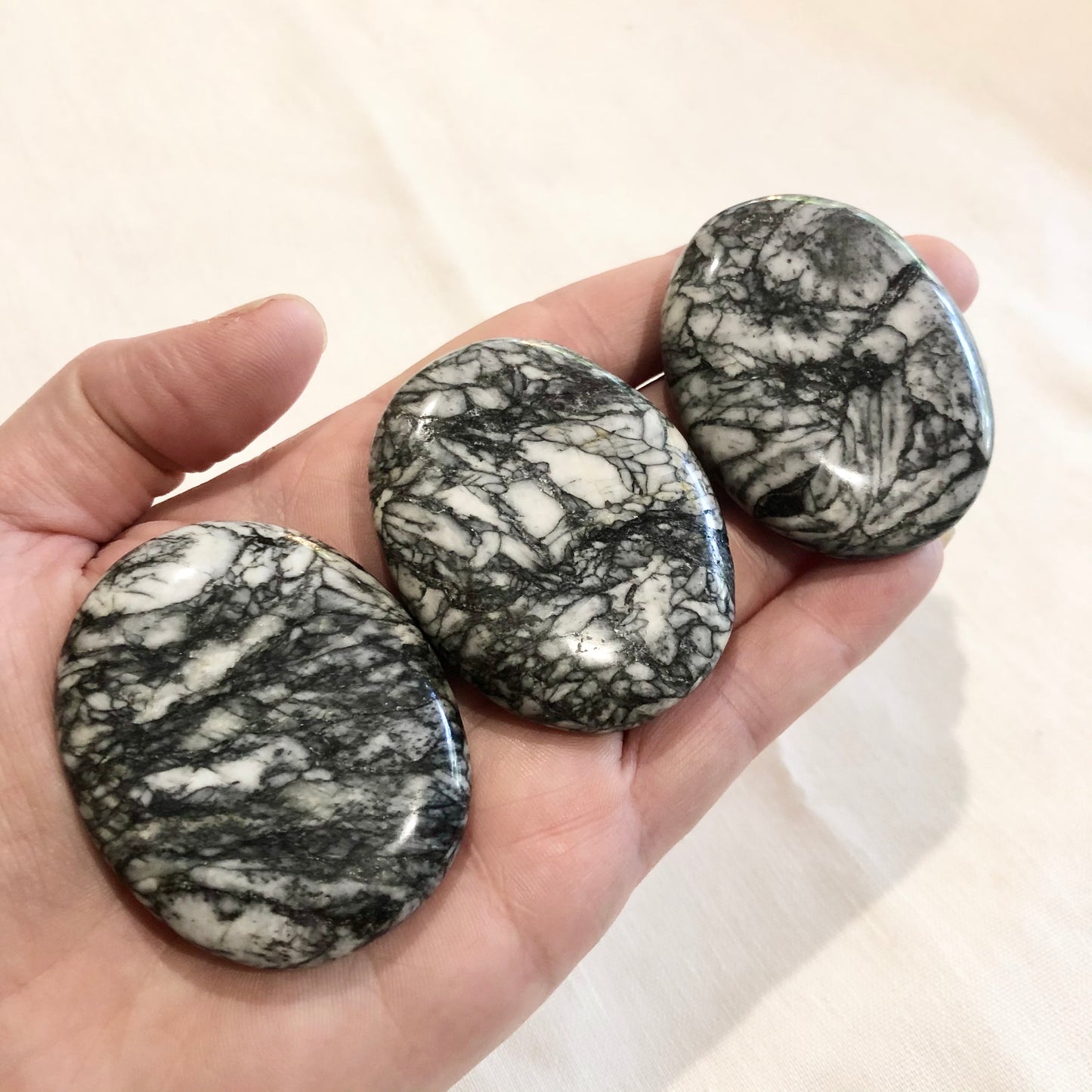 Pinolite crystal polished palm stone