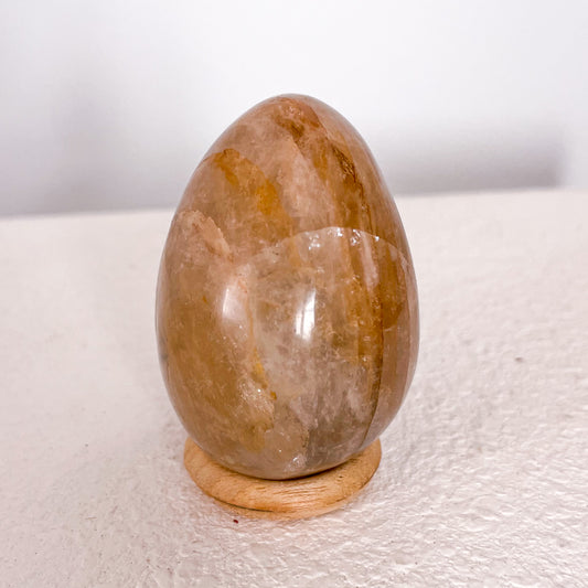 Golden healer quartz crystal polished egg with stand