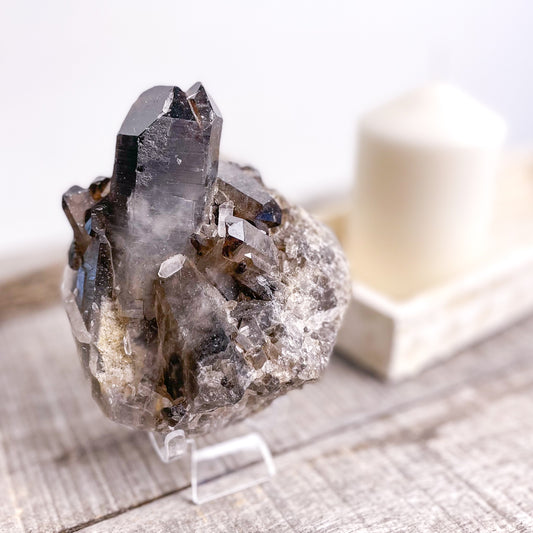 Smoky quartz crystal cluster on stand
