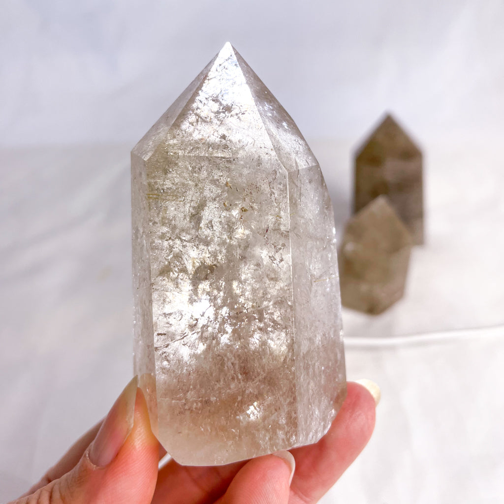 Smoky quartz crystal generator tower with inclusions