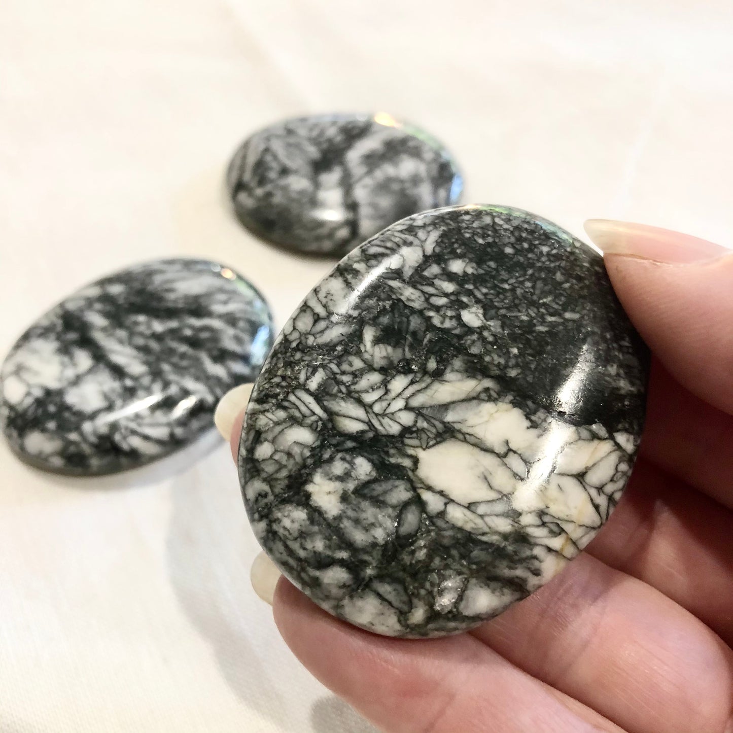 Pinolite crystal polished palm stone